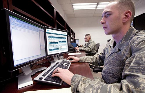 Male soldier sitting at a computer