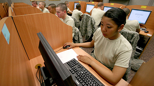 African American soldier sitting at a computer taking a test